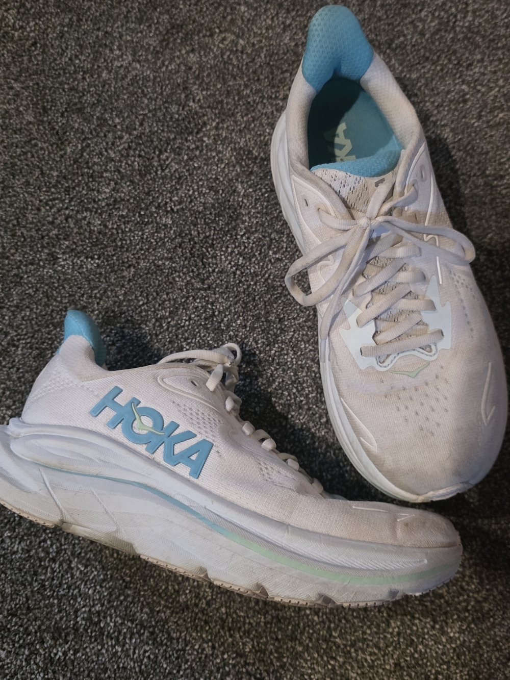 HOKA Clifton 10 running shoes, specifically in the White/Cielo Blue Size 7B Wmns